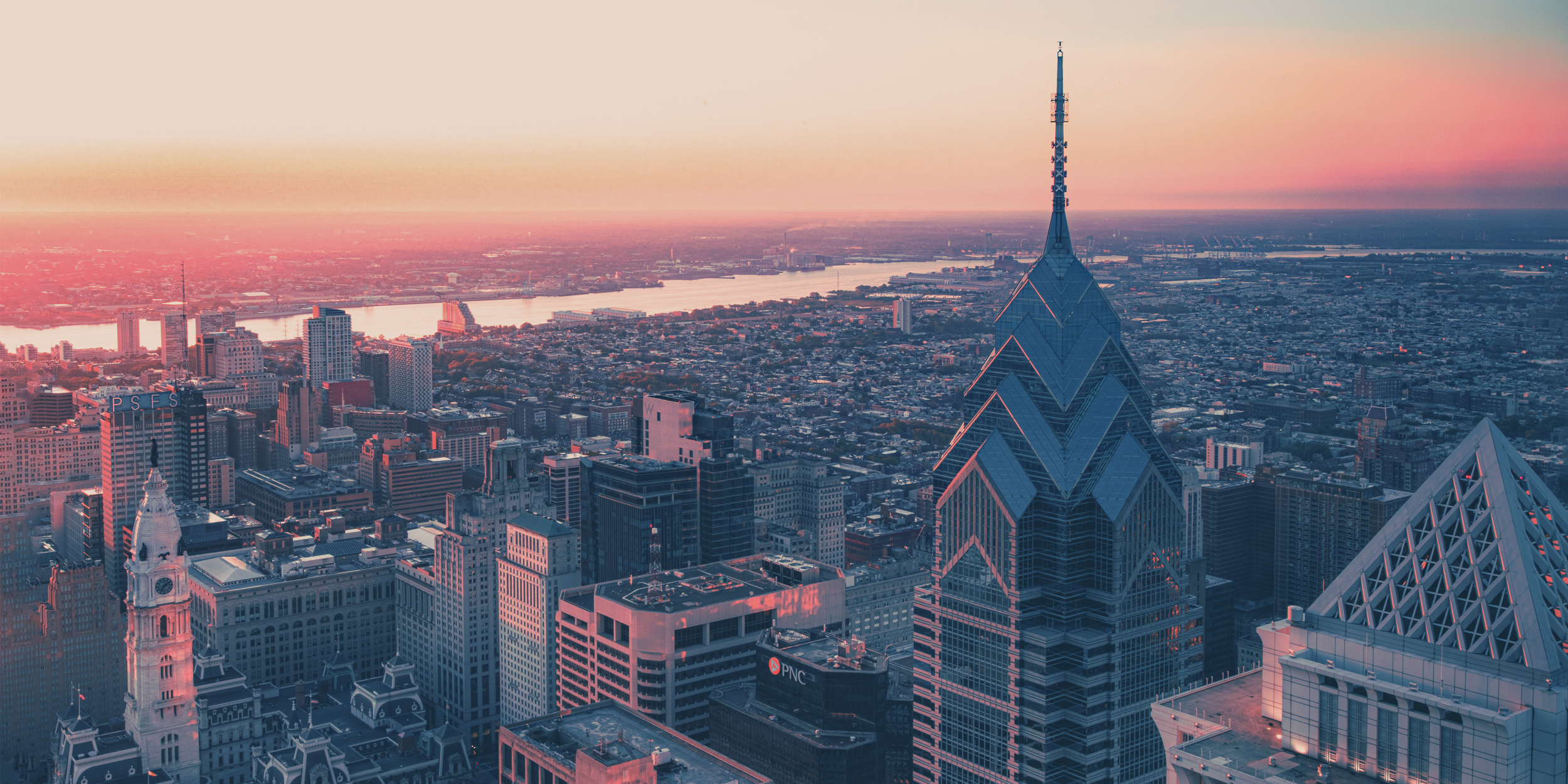 city skyline during sunset with rainbow